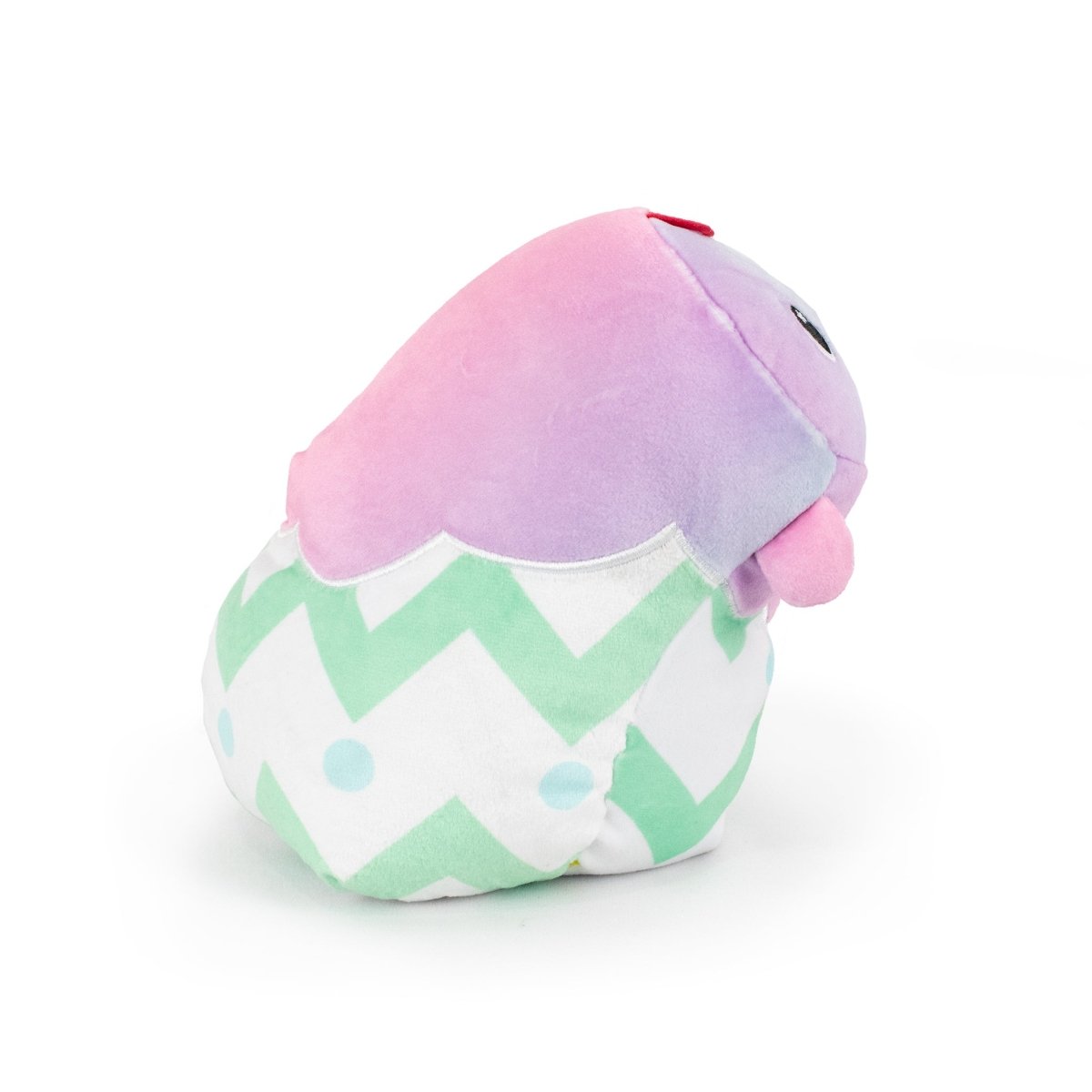 Meet Frederick the Chick Hatchling, an ultra-soft plush toy in a pastel purple and pink gradient. Its cute face and green-white zigzag body with blue dots make it ideal for cuddles or as an Easter Basket Buddy on a white surface.