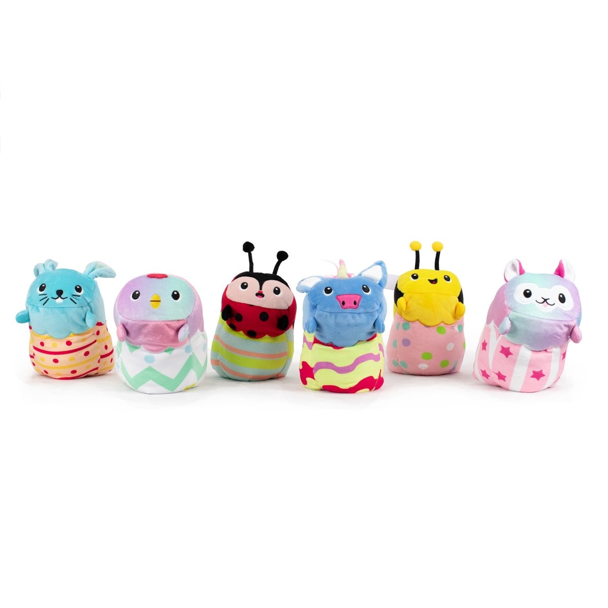 A collection of six plush toys, including Vee the Bee Hatchling, features a bunny, bird, ladybug, monster, bumblebee, and cat. Each toy showcases unique patterns like stripes, polka dots, and stars on their bodies or clothing for extra sensory softness.