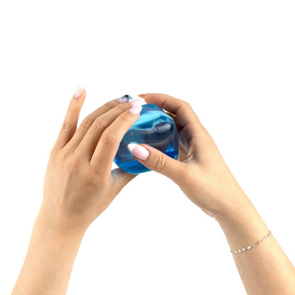 Two hands with manicured nails hold and squeeze Bubblegum's Favorite Toy - Solid Sugah-mals Cubes against a white background.
