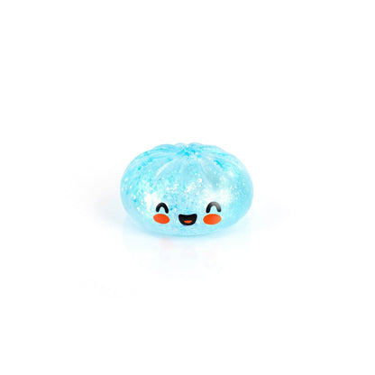 Bubblegum's Favorite Toy - Mystery Dumpling is a small, round, light blue squishy with glitter inside and a smiling face featuring big eyes and rosy cheeks, perfect as a Sugar-mals Dumplings stress relief toy.