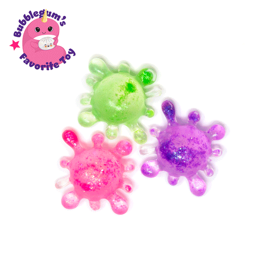 Three colorful splat-shaped toys—green, pink, and purple—are displayed on a white background. In the top left corner, a pink cartoon character appears with the text “Bubblegum’s Favorite Toy.” The Bubblegum’s Favorite Toy - Splat Squishy is perfect as a sensory toy or for squishy stress relief fun.