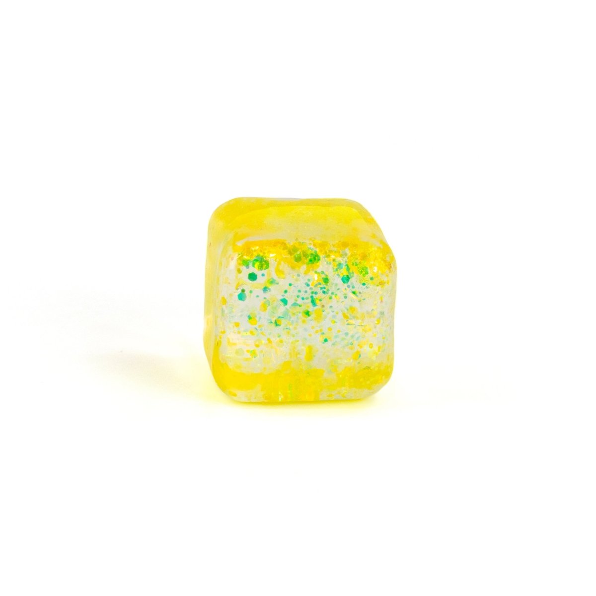 A single yellow-tinted Bubblegum's Favorite Toy - Glitter Sugah-mals Cube with green and white speckles, shown on a white background—a squishy cube ideal for stress relief.