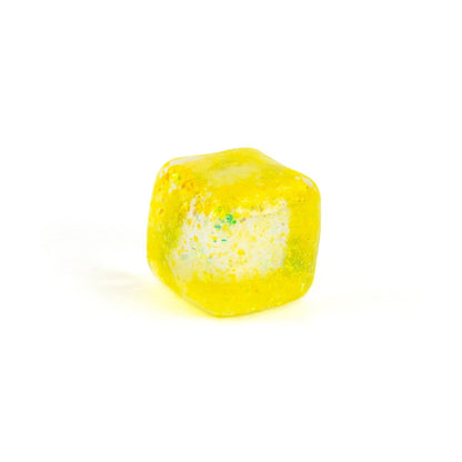 A yellow, translucent, squishy cube-shaped candy with a white center and colorful specks, inspired by Bubblegum's Favorite Toy - Glitter Sugah-mals Cubes, displayed on a plain white background.