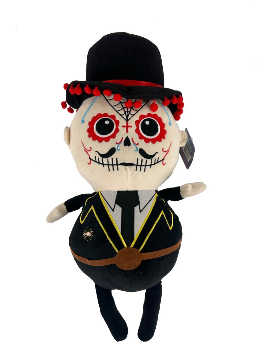 The Lil 'Migos Day of the Dead Plush boasts a sensory-soft build, sugar skull face, black hat with red pom-poms, yellow-trimmed suit, and brown belt—ideal for any plush couple collection. Shown on a white background.