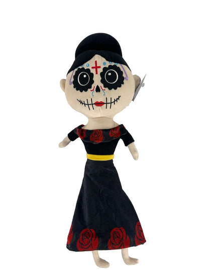 The Lil 'Migos Day of the Dead Plush features a painted skull face, colorful designs, a red cross on its forehead, and wears a black hat, black top, long black skirt with red roses, and a yellow belt.