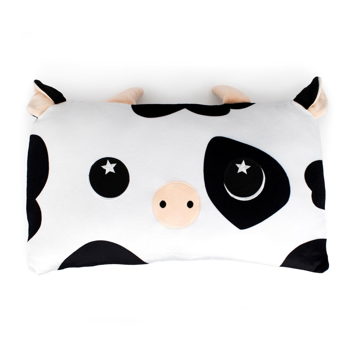 Leche the Cow Sleep Pillow is a rectangular cartoon cow pillow with black and white spots, a beige snout, starry eyes, and cute horns—perfect as a cuddly pillow or stuffed animal.