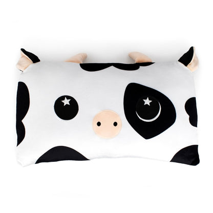 Leche the Cow Sleep Pillow is a rectangular cartoon cow pillow with black and white spots, a beige snout, starry eyes, and cute horns—perfect as a cuddly pillow or stuffed animal.