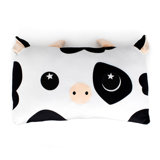Leche the Cow Sleep Pillow is a rectangular cartoon cow pillow with black and white spots, a beige snout, starry eyes, and cute horns—perfect as a cuddly pillow or stuffed animal.
