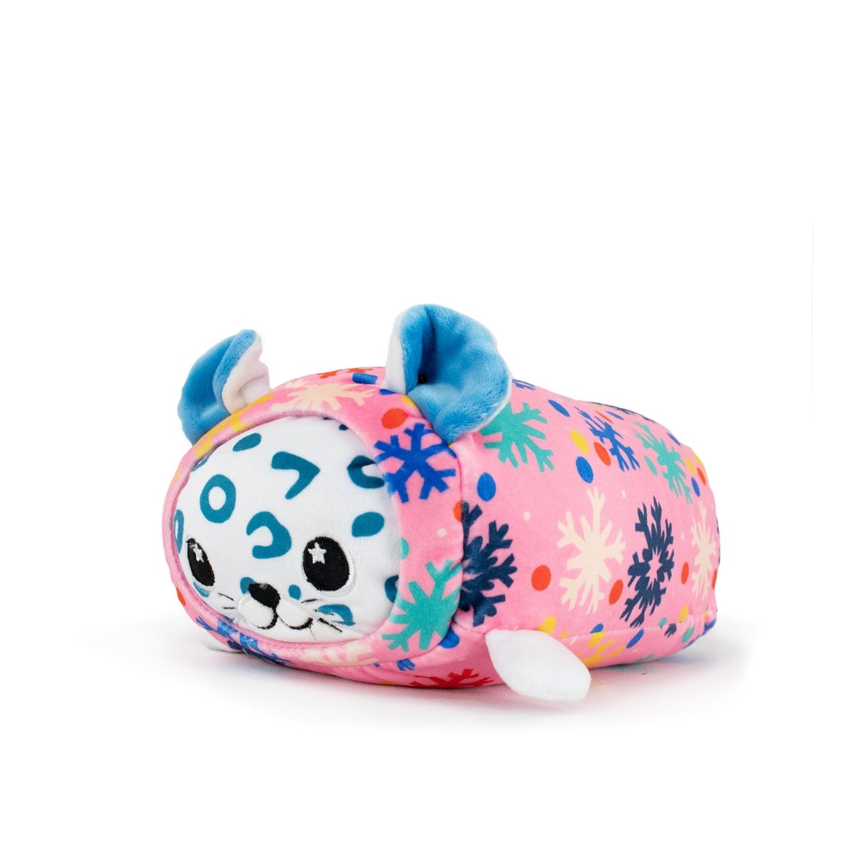 Snowie the Snow Leopard Slumber is a Christmas plush cat with blue spots, blue inner ears, and a smiling face, wrapped in a pink blanket decorated with colorful snowflakes—ideal for holiday décor.
