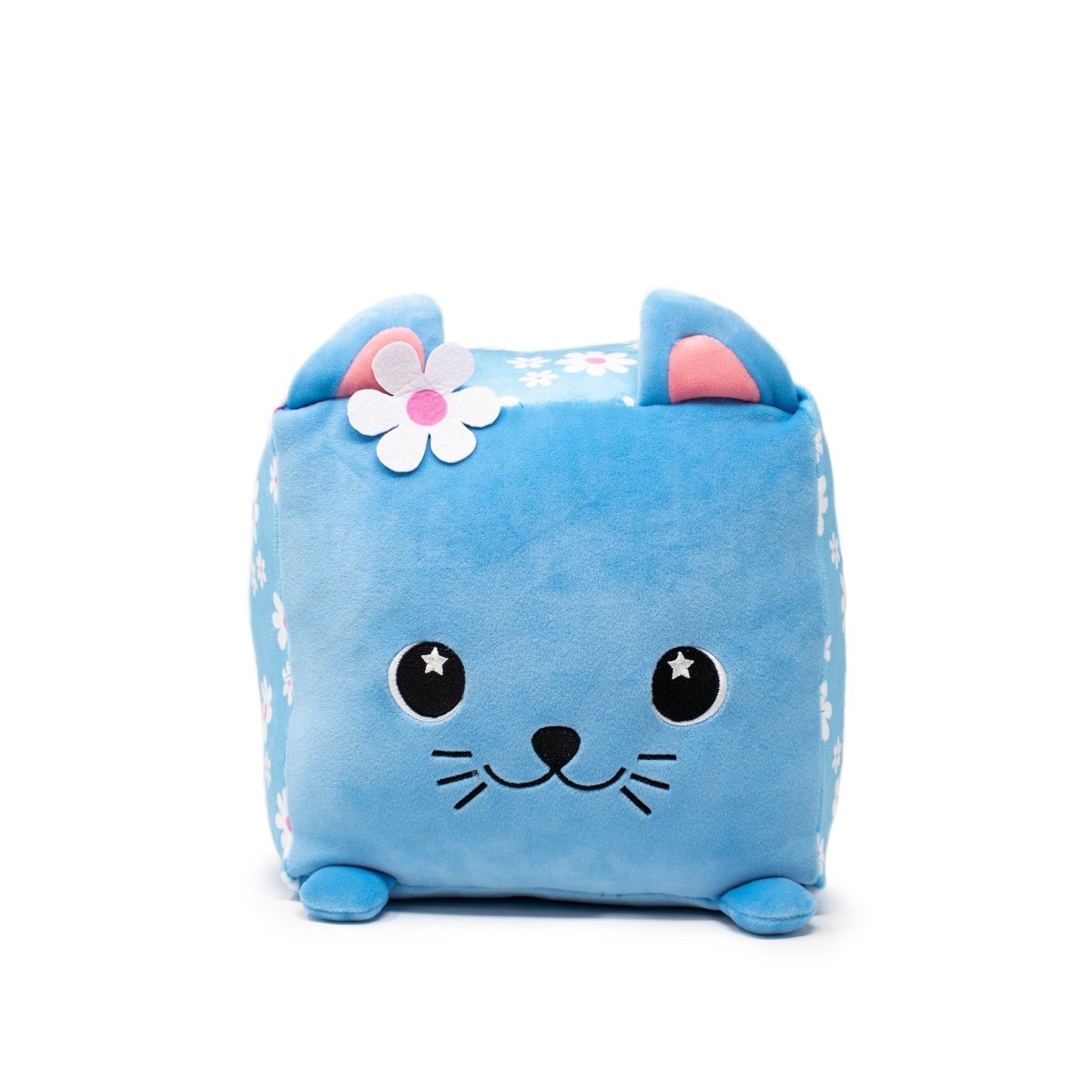 Maisie the Cat Plushie is a charming cube-shaped plush with pink inner ears, embroidered eyes, and a smiling face. A pink and white flower sits on its head, complemented by small corner paws and cute white flower patterns adorning this adorable toy.