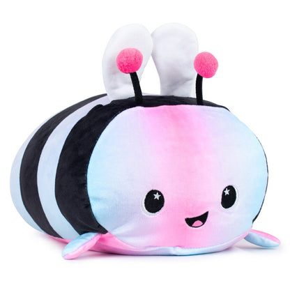 Introducing Melody the Bee Plushie, a toy with pastel pink, blue, and purple hues. Her bright smile and starry black eyes sparkle above black antennae with pink tips. With soft white wings and sensory softness, she's ideal for Easter Basket Buddies.