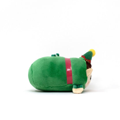 Jingle the Elf Clip-On is a small, round holiday plushie in a green elf costume with a pointy hat, lying on its side against a white background—perfect as a festive stuffed keychain.