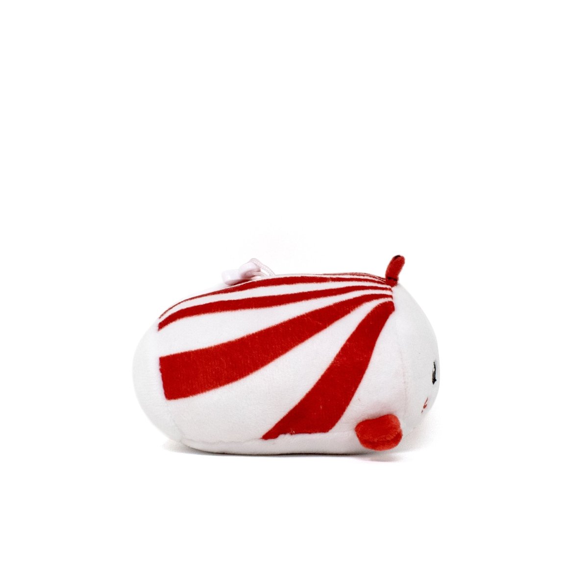 Mintie the Mint Clip-On is a small, round plush toy resembling a peppermint candy, featuring a white and red striped pattern with small red ears and feet on its soft white body. It has an endearing face that can be seen from the side.