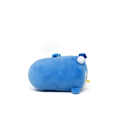 Peckington the Penguin Clip-On, a cute plushie shaped like a blue penguin, lies on its side showcasing soft flippers and a small yellow beak. A white pom-pom adorns its head, enhancing its charm against the plain white background.