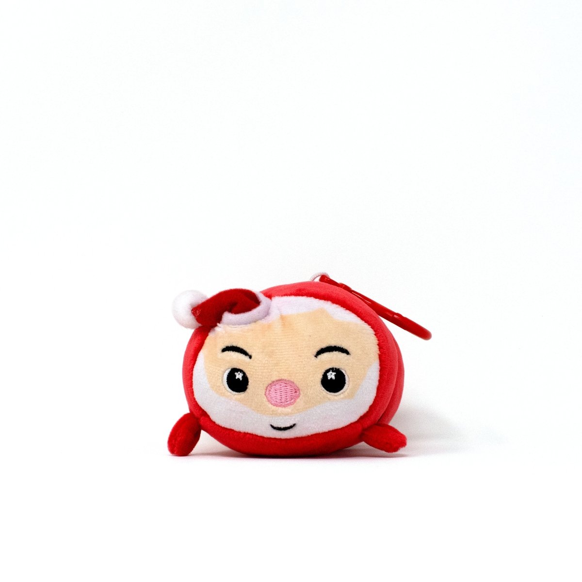 The Santa Clip-On is a round, plush toy with a red hat, white beard, and rosy cheeks—ideal as a festive Christmas plush or cute Santa keychain. Set against a plain white background.