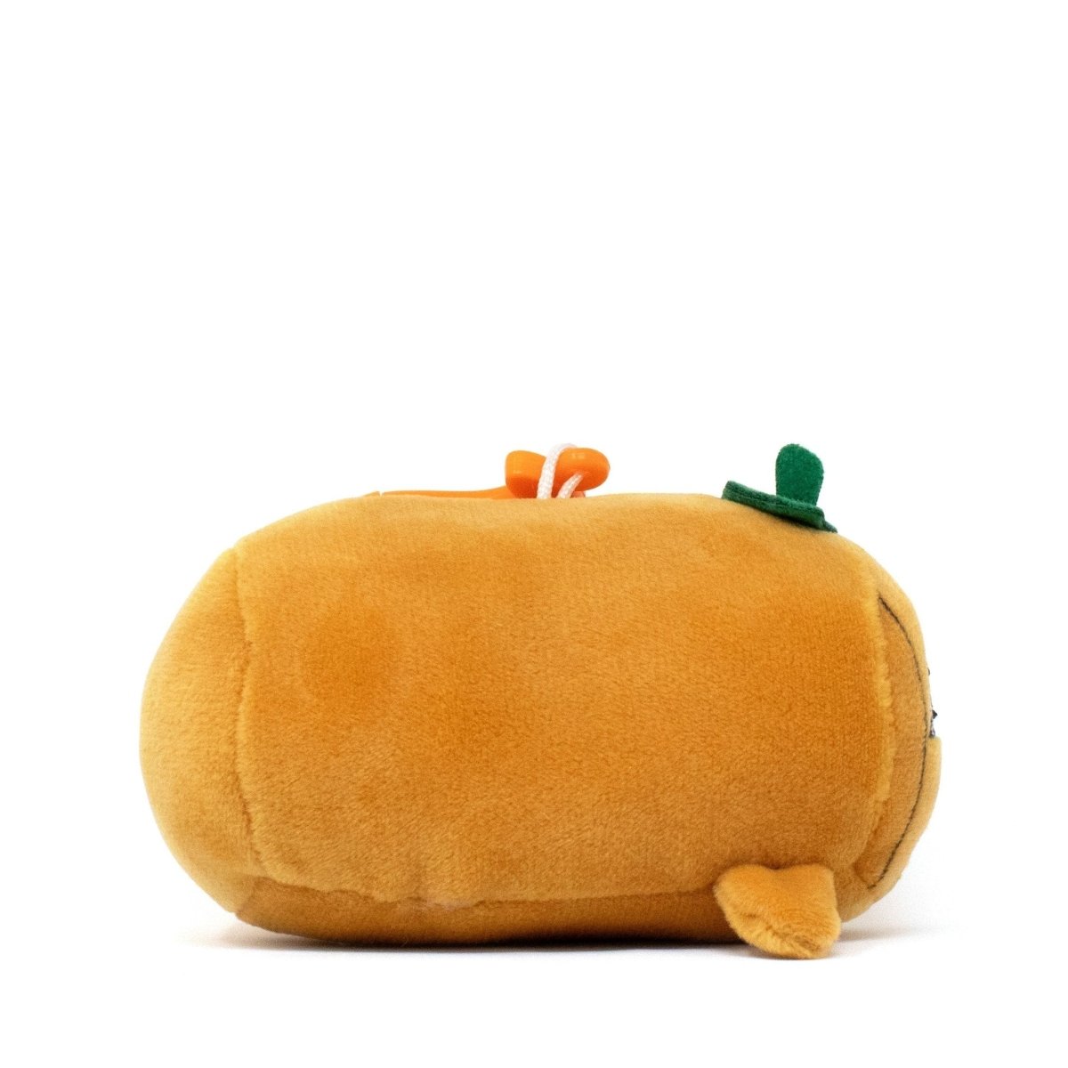 Vincent the Pumpkin Clip-On is a soft, minimalistically designed plushie shaped like an orange pumpkin loaf with a green leaf and brown stem on top, lying on its side. This Moosh-Moosh Spooky Series toy is irresistibly huggable.
