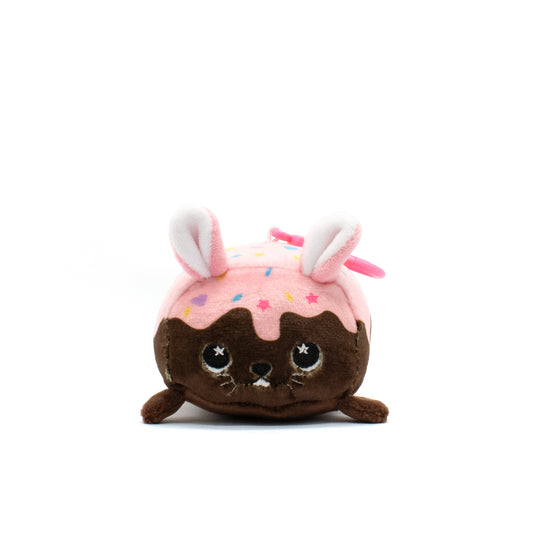 Introducing "Harry the Bunny Plush Clip-On," an adorable brown bunny plush with floppy ears, dressed in pink frosting-like fabric with sprinkles. This charming, round toy is a perfect Valentine's Day gift for anyone who loves sweet and cute surprises.