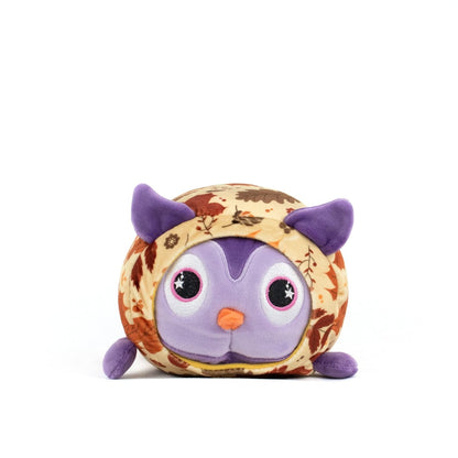The Archie Spooky Slumber Plushie is a round, ultra-soft stuffed owl with big purple eyes, purple ears and feet, and a body featuring a brown and orange autumn leaf pattern, shown on a plain white background.