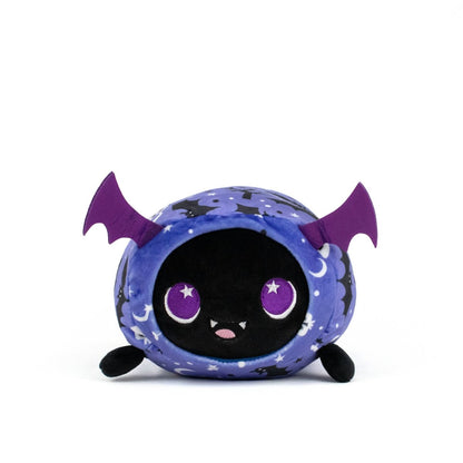 Cassie Spooky Slumber Plushie is a round, ultra-soft bat toy with purple wings, big purple eyes, a small smiling mouth, and a starry blue and black body, pictured against a plain white background.