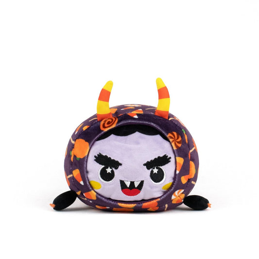 Meet the Fang Spooky Slumber Plushie: an ultra-soft, round stuffed toy with a purple face, fangs, angry eyes, candy corn horns on a patterned hood, small black arms and feet. It’s machine washable for easy care.