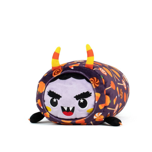 The Fang Spooky Slumber Plushie is an ultra-soft, machine washable plush toy with a round purple body, orange candy and swirl patterns, a mischievous face, striped horns, small black ears, and tiny black feet.