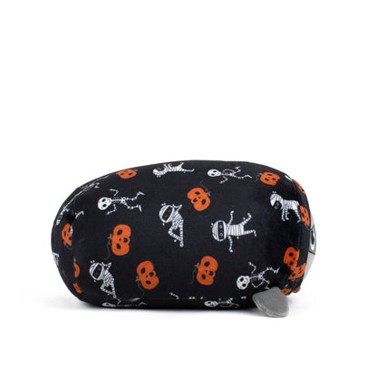 The Nile Spooky Slumber Plushie is a cat-shaped stuffed toy made from ultra-soft, machine-washable fabric. It features black fabric with orange pumpkins, skeletons, and mummies, plus a gray tail and blue eyes for extra charm.