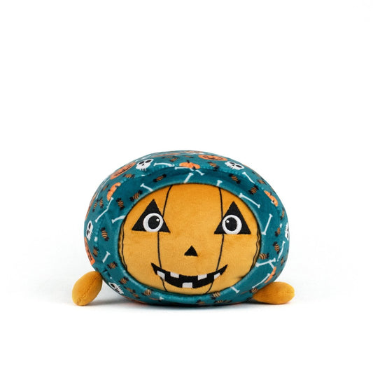The Vincent Spooky Slumber Plushie is a round, ultra-soft plush with an orange jack-o'-lantern face, black eyes and mouth, small orange feet, and teal fabric patterned with skulls, bones, and spiders.