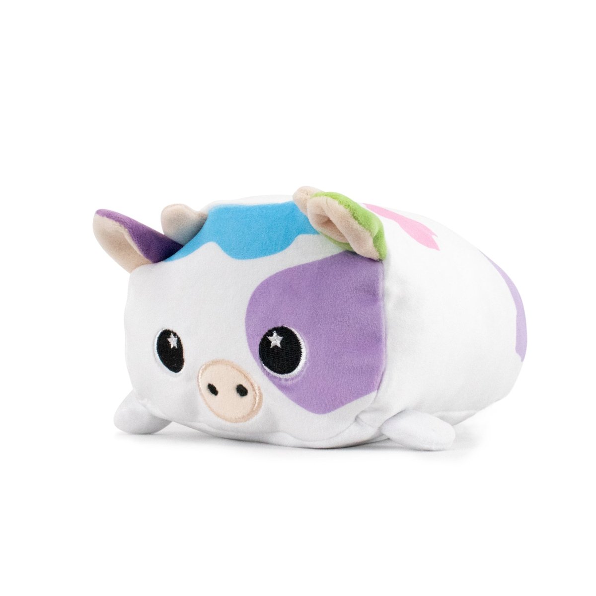 Mootilda the Cow Plushie is an Easter-themed plush toy featuring pastel colors, like purple ears, light green spots, and a blue patch on its back. Made from ultra-soft materials, it has black starry eyes and a small pink snout, resting on a white surface.