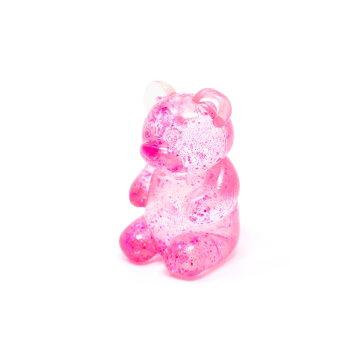 A sparkling, pink, translucent bear-shaped gummy candy from “Bubblegum’s Favorite Toy - Glitter Maltose Bears,” featuring shimmering accents and displayed against a plain white background.