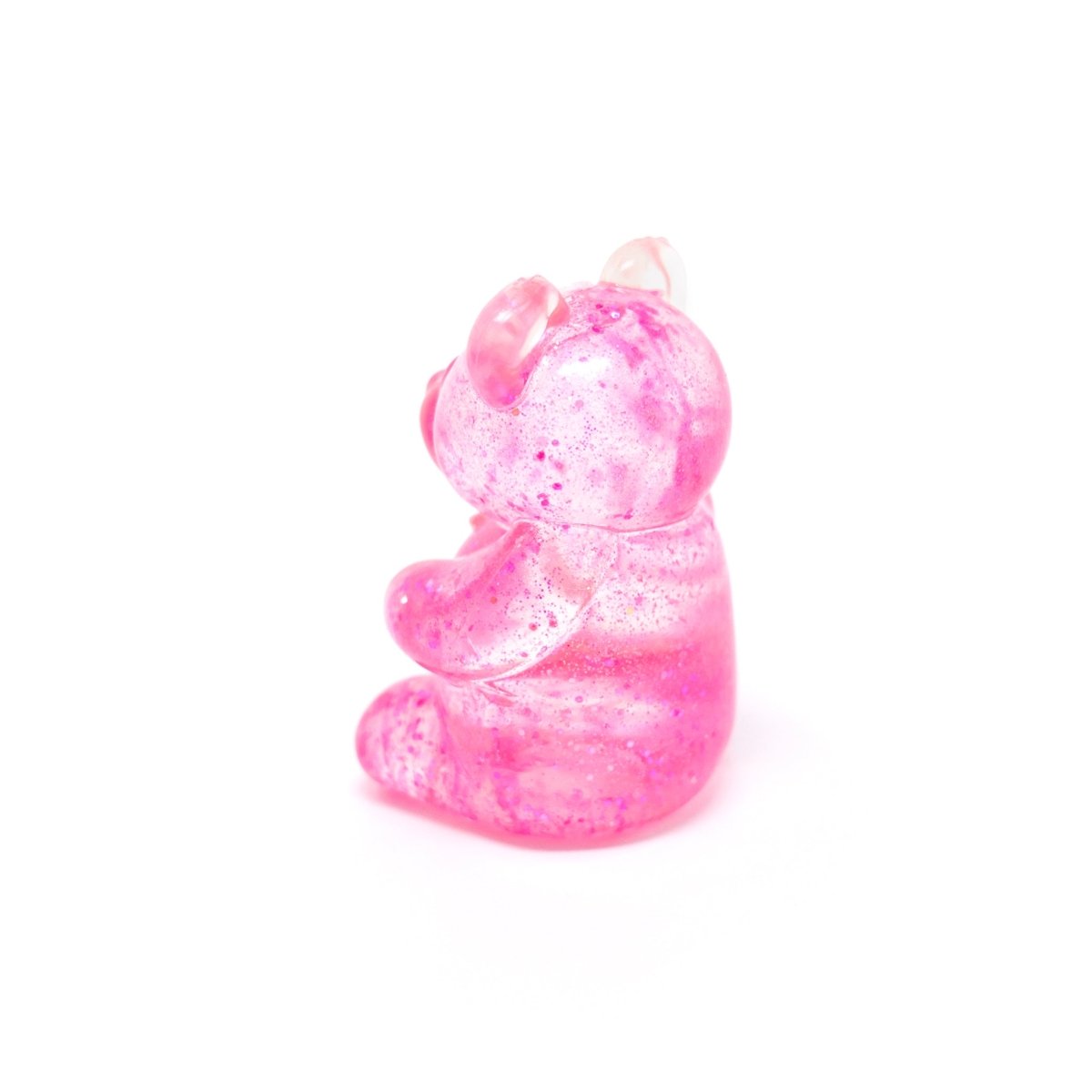 A translucent pink “Bubblegum’s Favorite Toy - Glitter Maltose Bears” figurine, sprinkled with glitter, sits upright and slightly turned to the left on a plain white background—an irresistibly cute sensory toy that provides squishy stress relief.