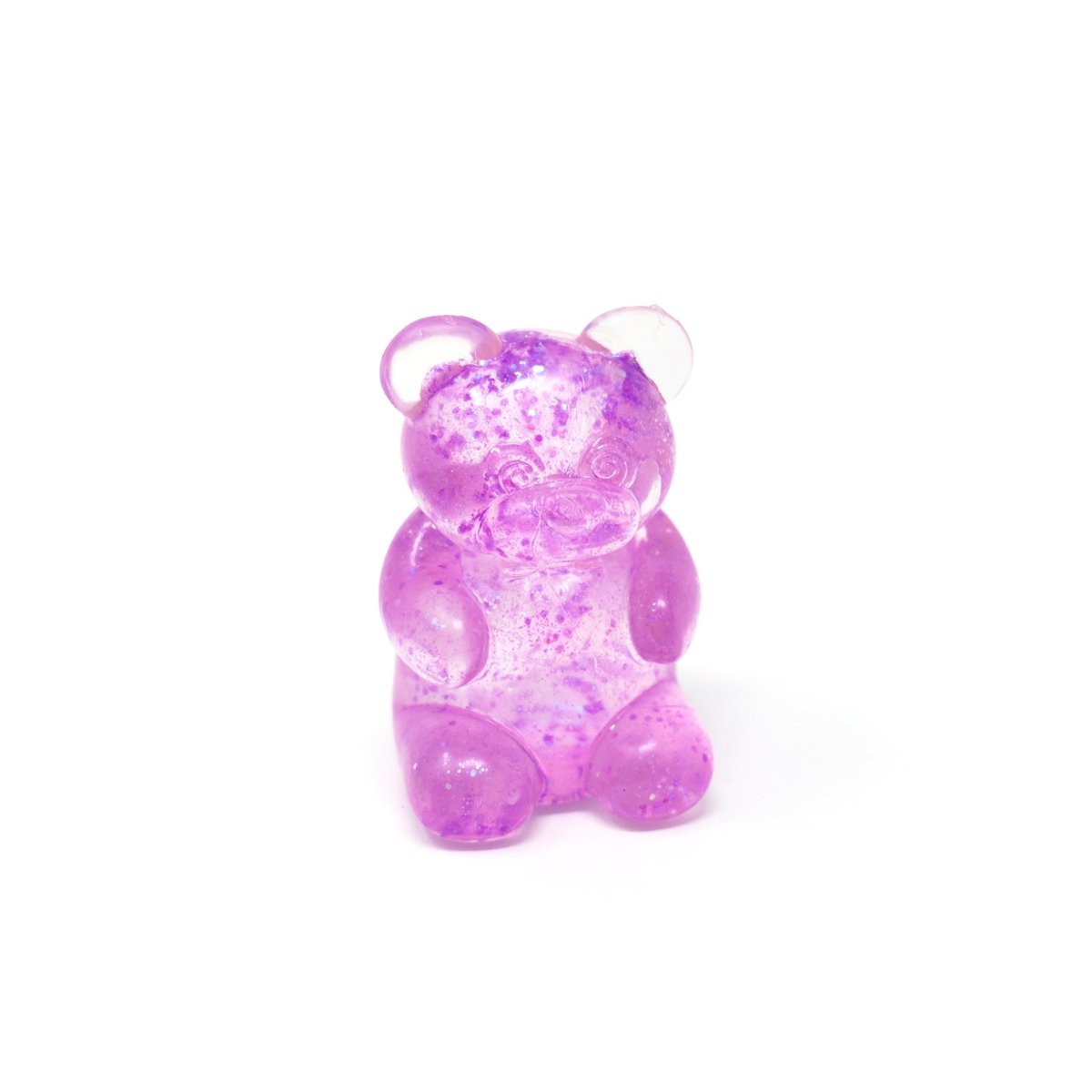 A translucent purple Glitter Maltose Bear from Bubblegum’s Favorite Toy, featuring small darker purple specks, sits upright on a white background—making it the perfect squishy stress relief sensory toy.