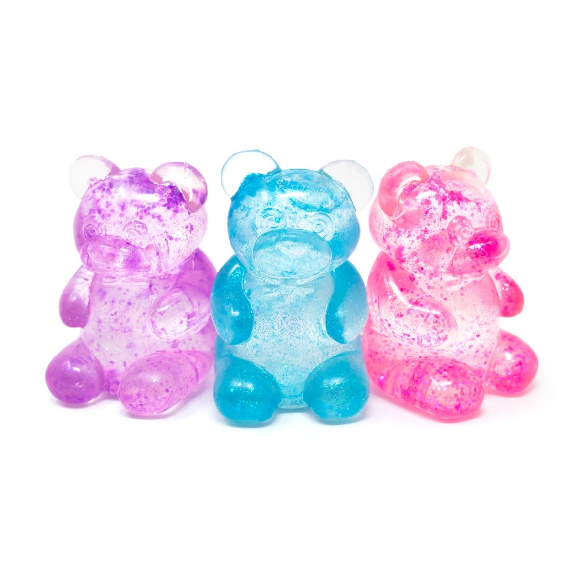 Three translucent gummy bear candies—purple, blue, and pink—sit side by side on a white background, each sparkling with glitter in a playful nod to Bubblegum’s Favorite Toy - Glitter Maltose Bears.