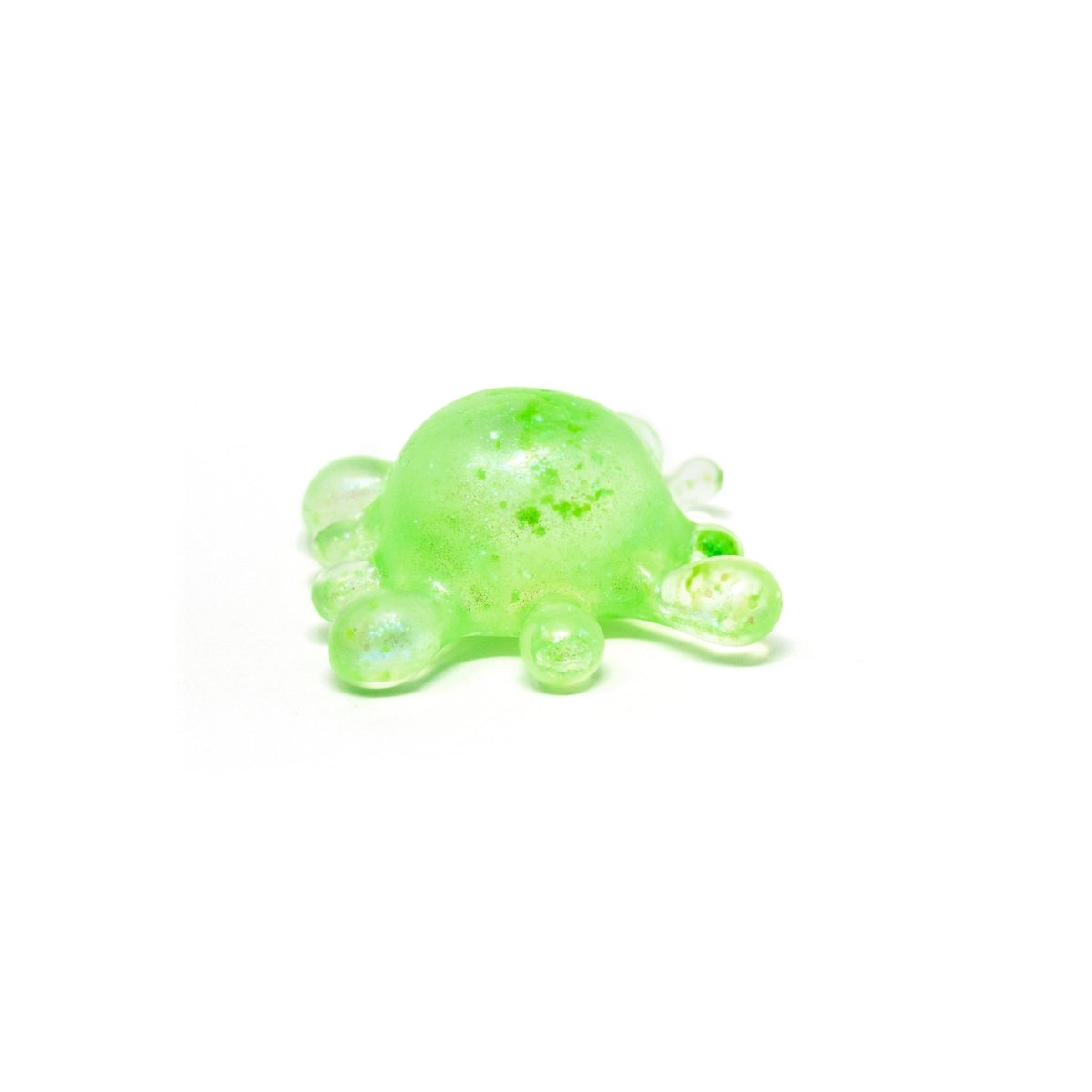 A small, green, semi-transparent blob with round protrusions sits on a white background, resembling a stylized germ or molecule. Perfect as a sensory toy or stress relief squishy, this delightful figure is inspired by Bubblegum’s Favorite Toy - Splat Squishy.