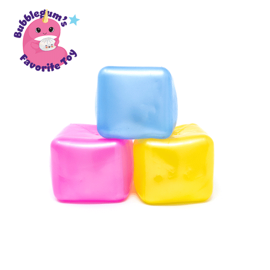 Three soft, colorful Sugah-mal Pearl Cubes from Bubblegum’s Favorite Toy—in blue, pink, and yellow—are stacked on a white background. A cute pink cartoon character and the text “Bubblegum’s Favorite Toy - Sugah-mal Pearl Cubes” appear in the top left corner.