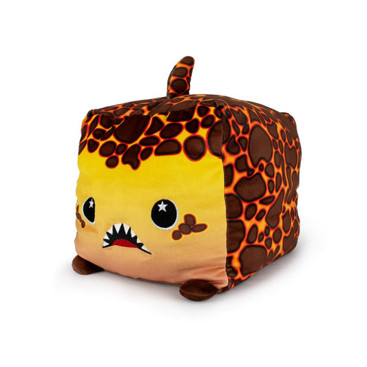 Pele the Lava Shark is a soft, machine-washable plush toy with a square block shape, yellow face, cartoon eyes, sharp white teeth, small brown feet, a tail, and a dark brown lava rock pattern.