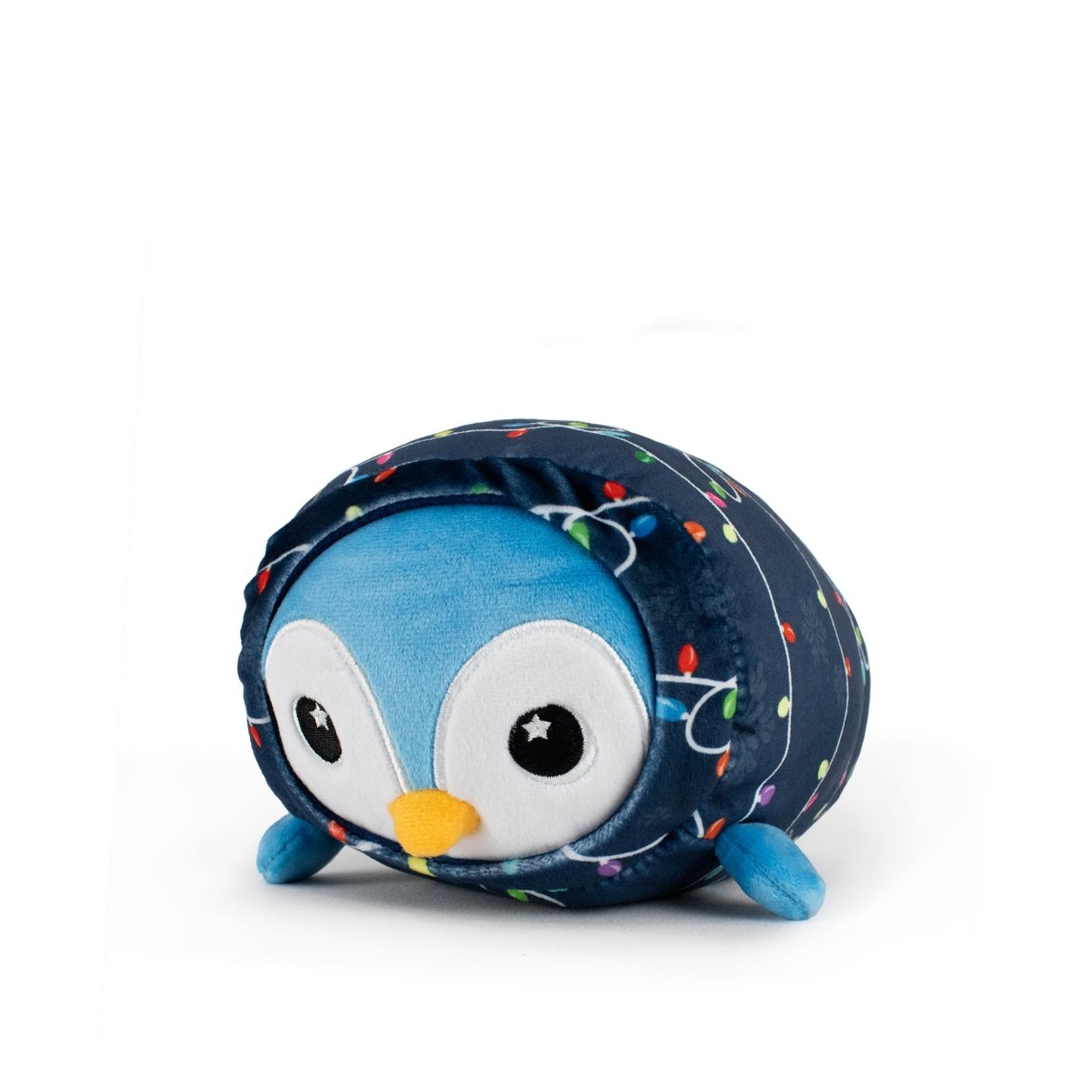 Peckington the Penguin Slumber is a cuddly blue plush penguin wrapped in a dark blue blanket with colorful string lights, featuring big round eyes and small flippers, shown against a plain white background.