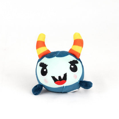 The Spike Spooky Plushy Skwishy is a round, blue plush toy with a light blue face, orange and yellow striped horns, black eyebrows, small fangs, blushing cheeks, and tiny flipper-like arms set against a white background.