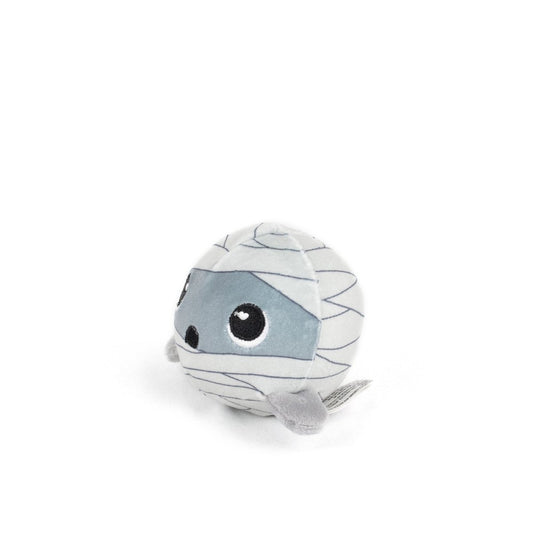 The Nile Spooky Plushy Skwishy is a round, plush mummy toy with big black and white eyes, gray bandages, and small gray arms, shown on a plain white background.
