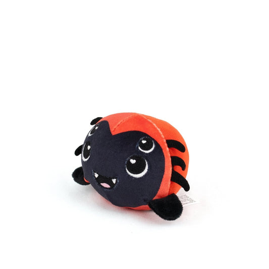The Muffet Spooky Plushy Skwishy is a round, cute, cartoon-like plush spider with a black face, four eyes, a red body, black legs, and a happy smile.
