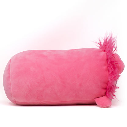 The pink Prince Val the Lion Plushie, featuring soft fur and a feathery tail, rests invitingly on a white background, ready to enchant you with its comforting softness.