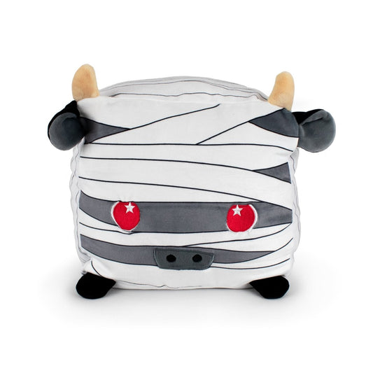 Ramsey the Sheep Mummy is a square, soft plush toy designed as a cute sheep wrapped in mummy bandages, featuring two tan horns, black ears, red eyes, small black nostrils, and black feet. Machine washable for easy care.