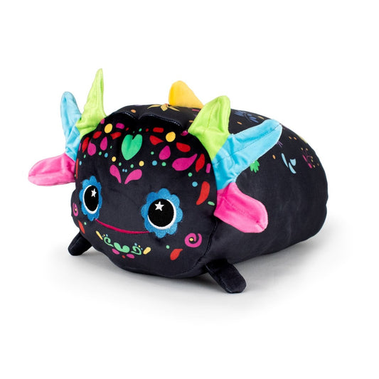 Reina the Axolotl is a cuddly plush with a black body, vibrant patterns, blue and green horns, pink ears, big round eyes, and a smiling face, inspired by Mexican folk art alebrijes.