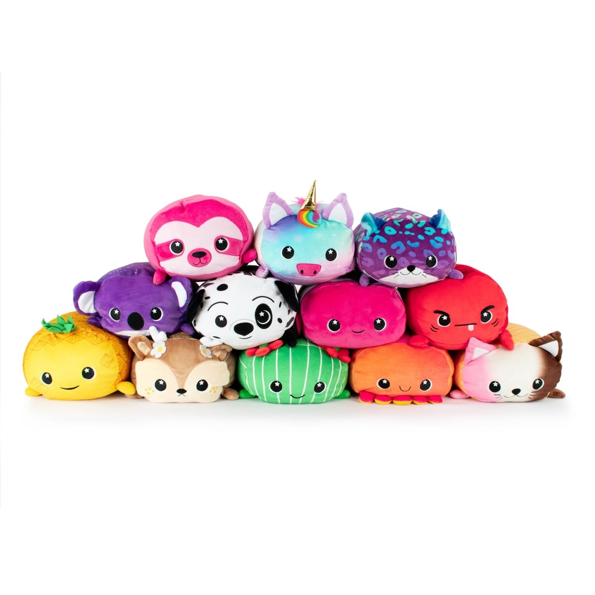 A pyramid of adorable plush toys includes a sloth, Chewmoca the Doe, a unicorn, dinosaur, panda, fox, pineapple, deer, watermelon, octopus, and a cat—all featuring big eyes and smiley faces.