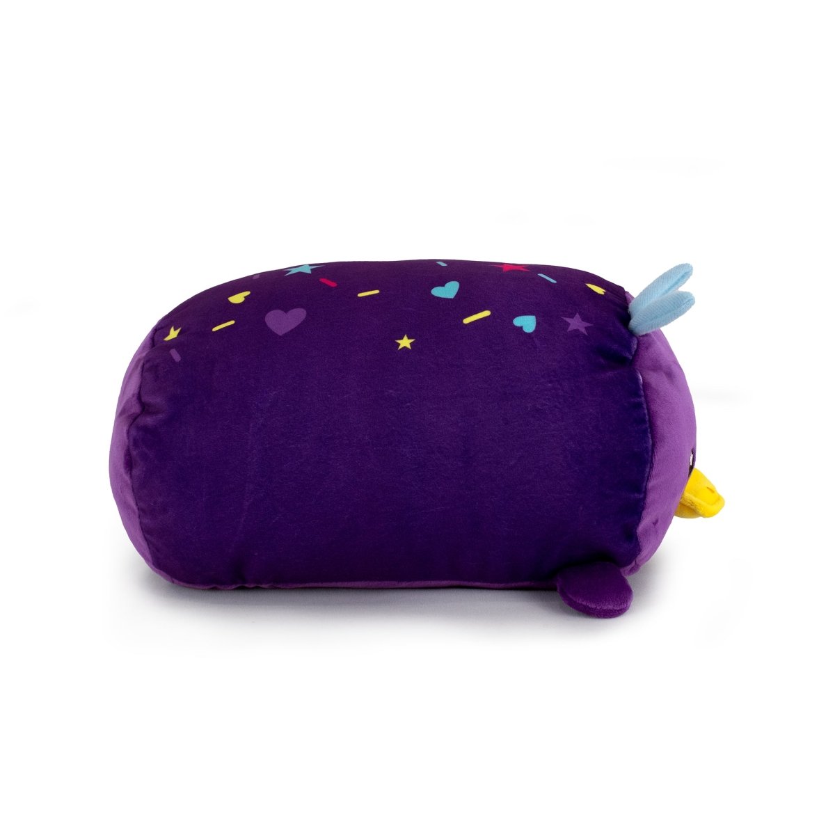 Sylvie the Platypus is a plush toy shaped like a rounded purple animal, decorated with colorful hearts, stars, and confetti. It features small blue ears, a yellow snout, tiny purple feet, and is conveniently machine washable.