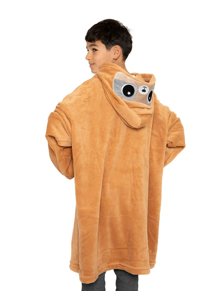 A young person in an oversized, tan Hooded Blanket - Speedy the Sloth, featuring cute animal eyes and ears, stands against a white background and looks over their shoulder.