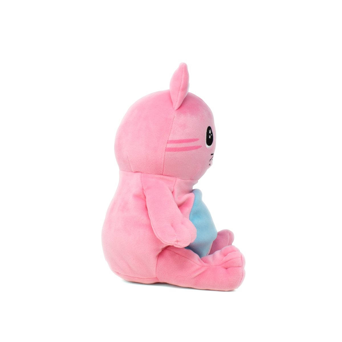 A side view of Kandy Kat the Pink Cat Starlight Buddy Plushie, an adorable pink plush toy with bunny ears and a round body. It features a blue patch on the front, large black eyes, and a neutral expression against a plain white background.