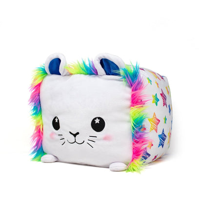 Stella the Lion Plushie is a cube-shaped toy with a cat face, starry eyes, pink cheeks, rainbow-colored fur on its sides and ears, and a pattern of colorful stars across its body.