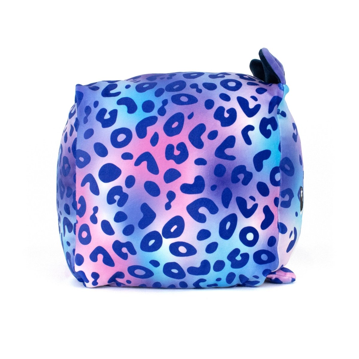 Tundra the Snow Leopard is a plush, cube-shaped stuffed toy with blue, purple, and pink leopard print, small fabric ears on top, and a side tail, shown against a white background.