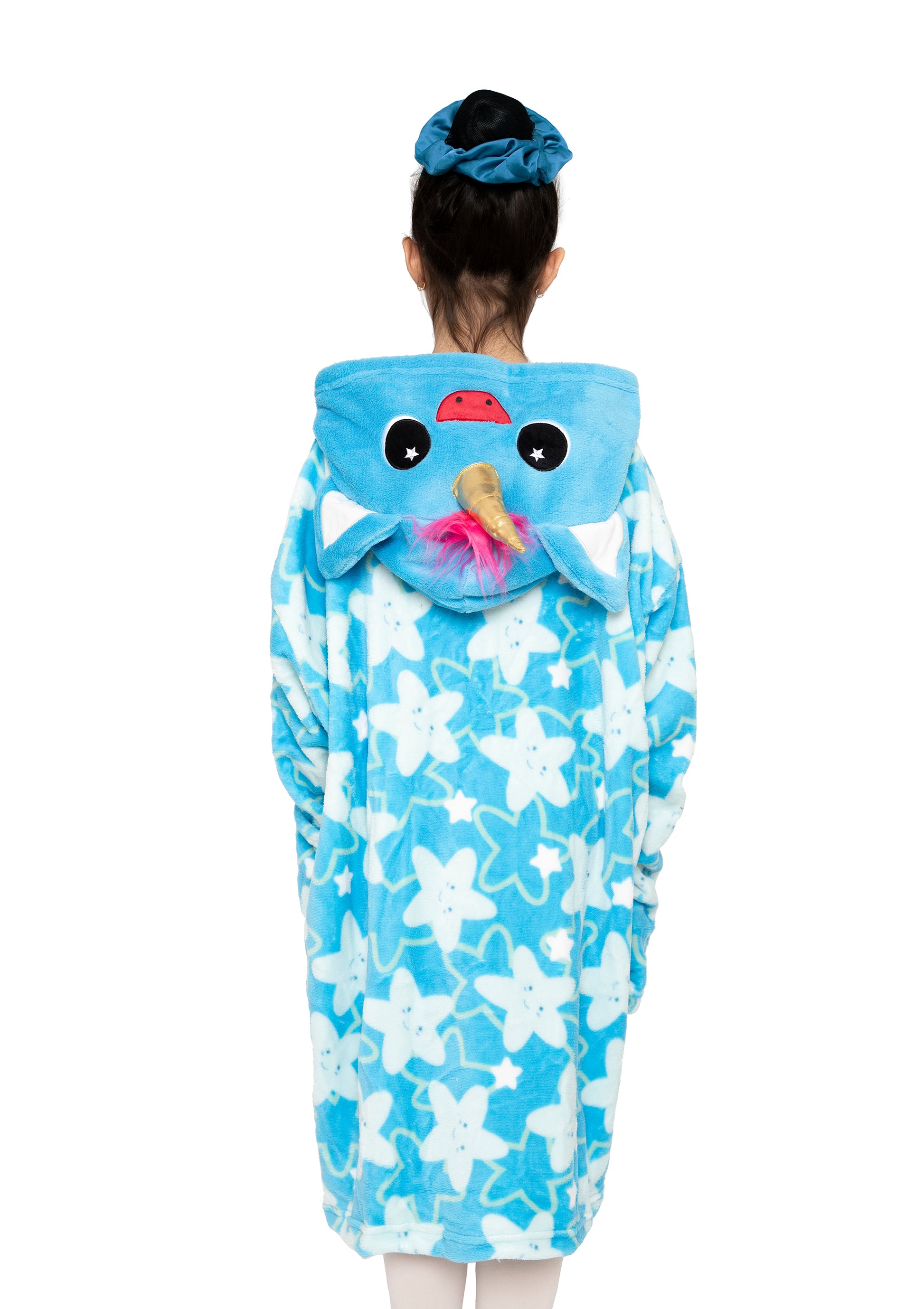 A person with a blue scrunchie is seen from behind wearing the "Hooded Blanket - Sparkle the Unicorn," featuring white star patterns plus a unicorn face, ears, eyes, and horn on the hood, against a white background.