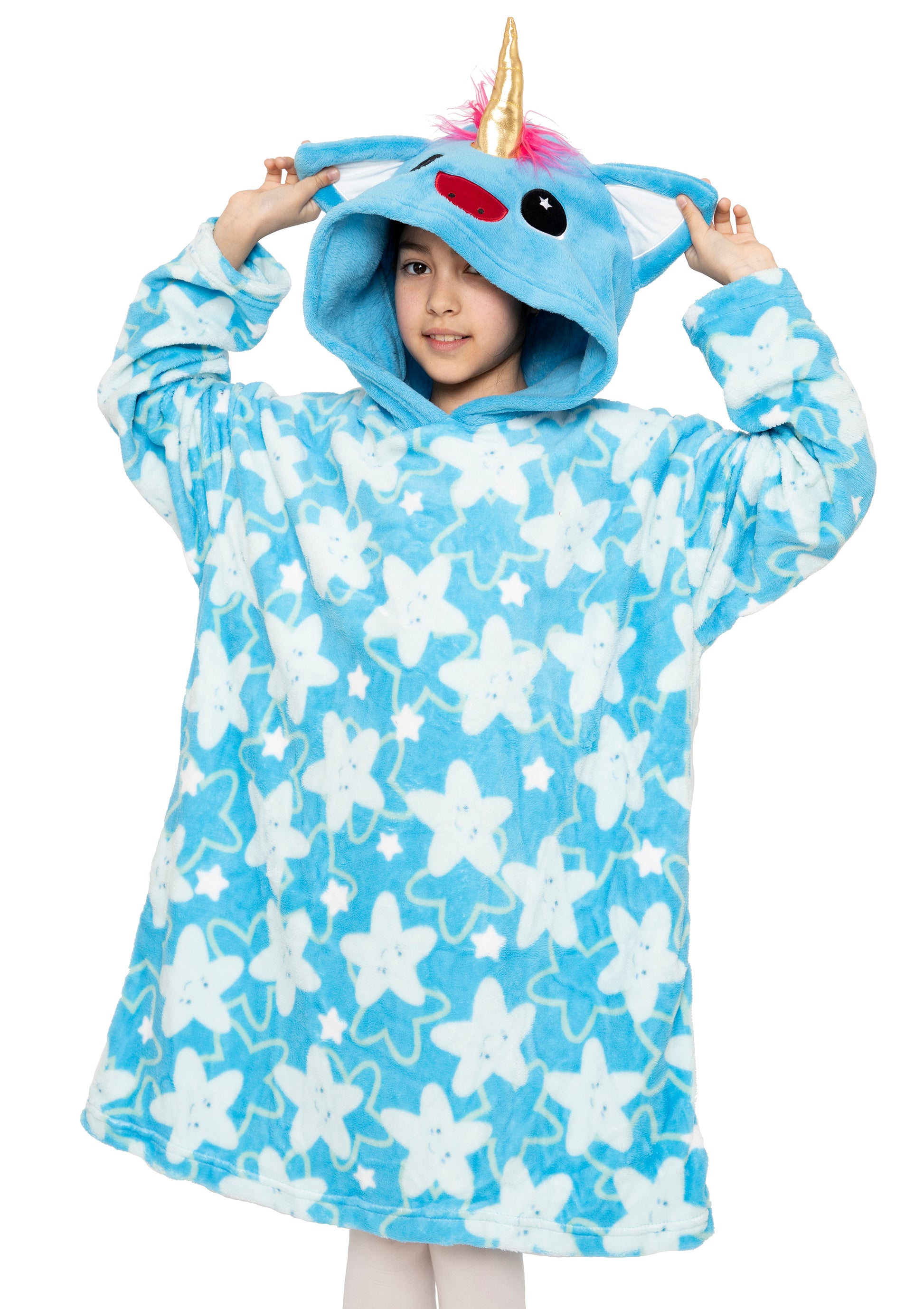 A child smiles while holding up the hood of the Hooded Blanket - Sparkle the Unicorn, a blue oversized blanket with white starfish print and a unicorn face, ears, pink mane, and yellow horn on the hood.